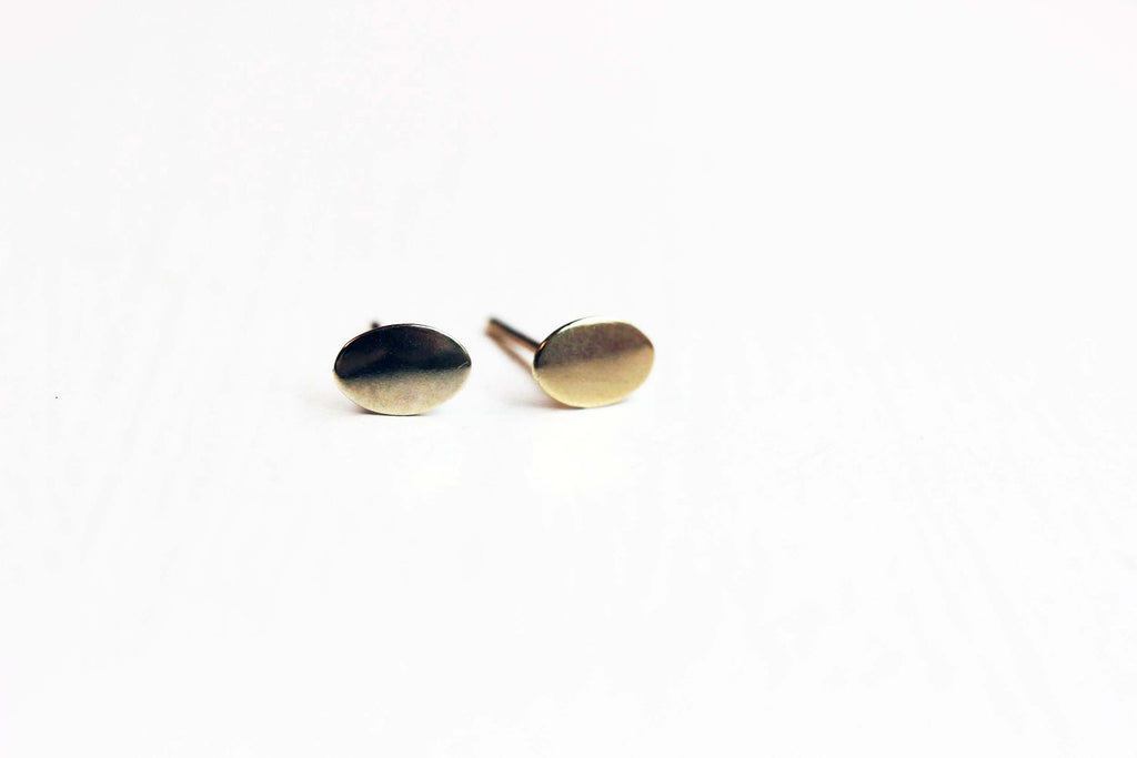 Gold oval dot studs from Diament Jewelry, a gift shop in Washington, DC.