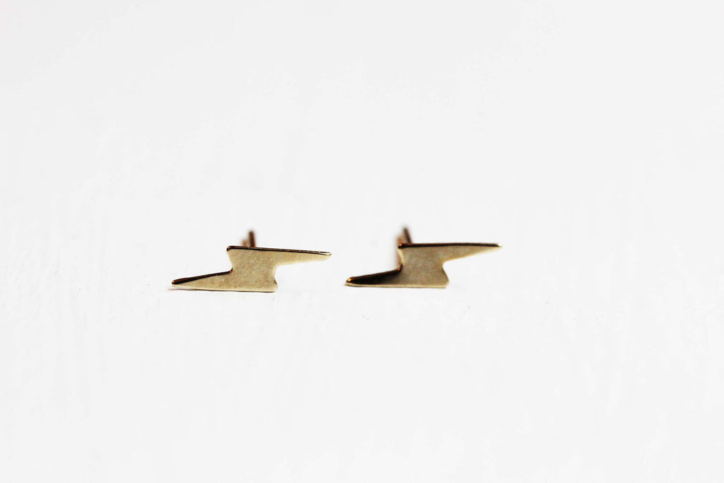 Tiny gold lightning bolt studs from Diament Jewelry, a gift shop in Washington, DC.