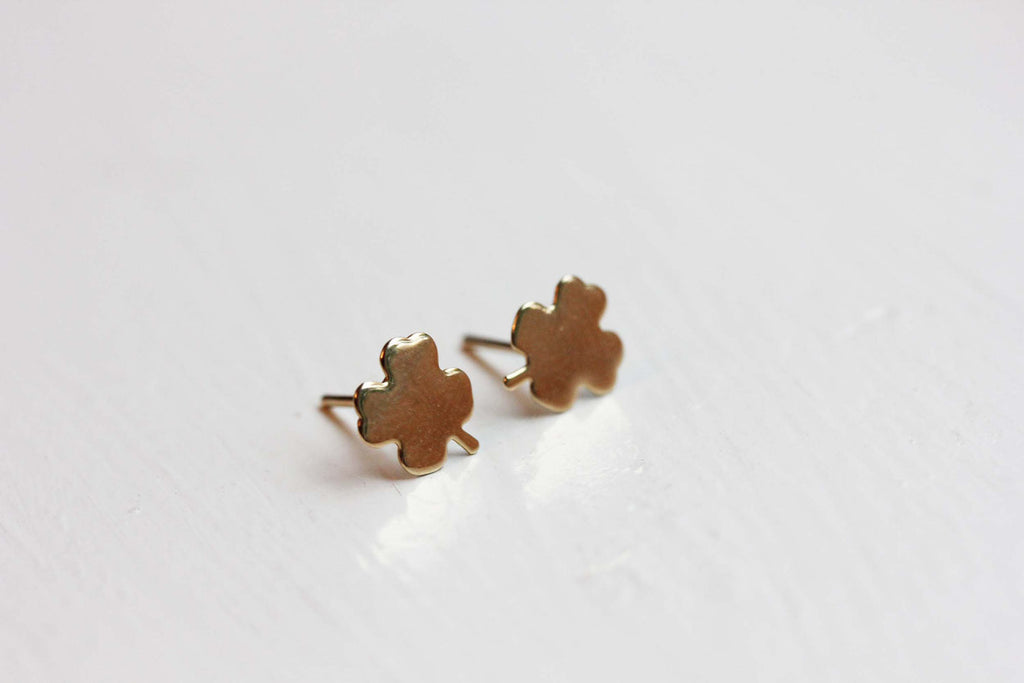 Small gold clover studs from Diament Jewelry, a gift shop in Washington, DC.