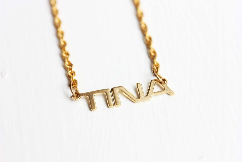 Vintage Tina gold name necklace from Diament Jewelry, a gift shop in Washington, DC.
