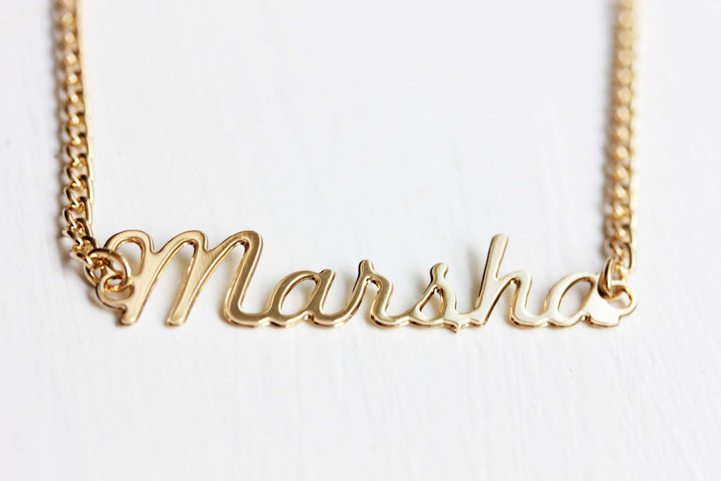 Vintage Marsha gold name necklace from Diament Jewelry, a gift shop in Washington, DC.