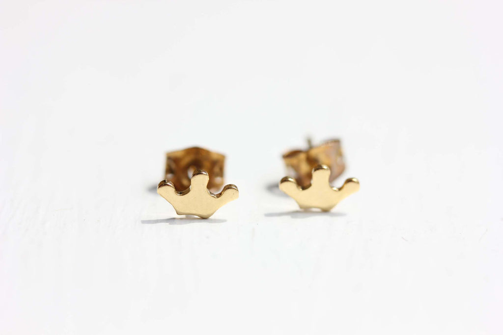 Tiny gold crown studs from Diament Jewelry, a gift shop in Washington, DC.