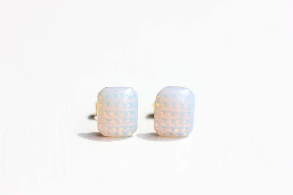 Square hologram studs from Diament Jewelry, a gift shop in Washington, DC.