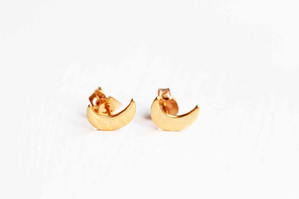 Gold moon studs from Diament Jewelry, a gift shop in Washington, DC.