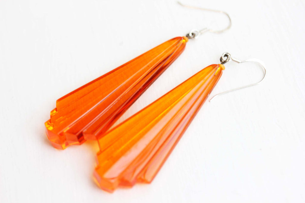 Orange art deco dangle earrings from Diament Jewelry, a gift shop in Washington, DC.