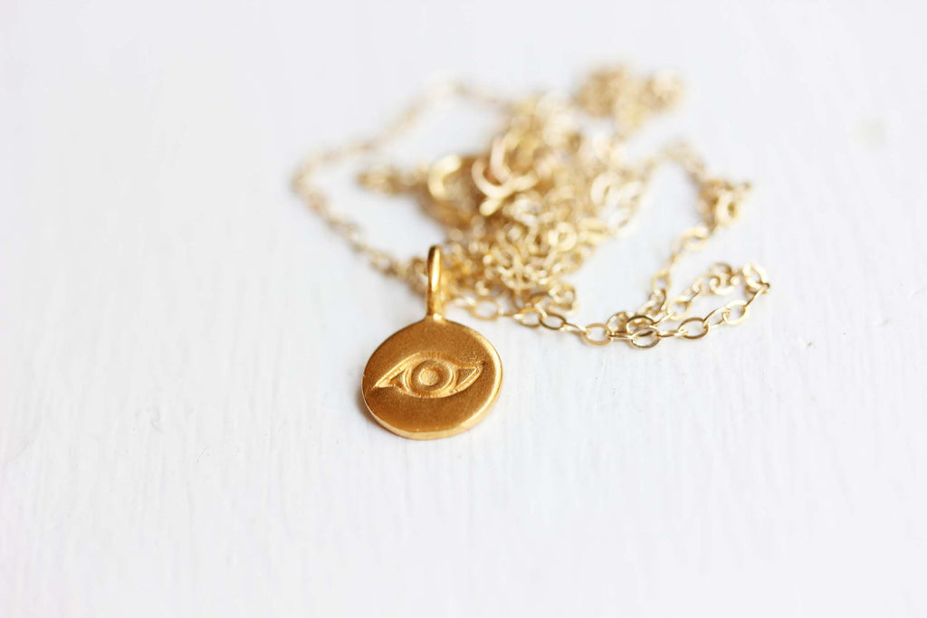 Tiny Evil Eye Gold Charm Necklace from Diament Jewelry, a gift shop in Washington, DC.