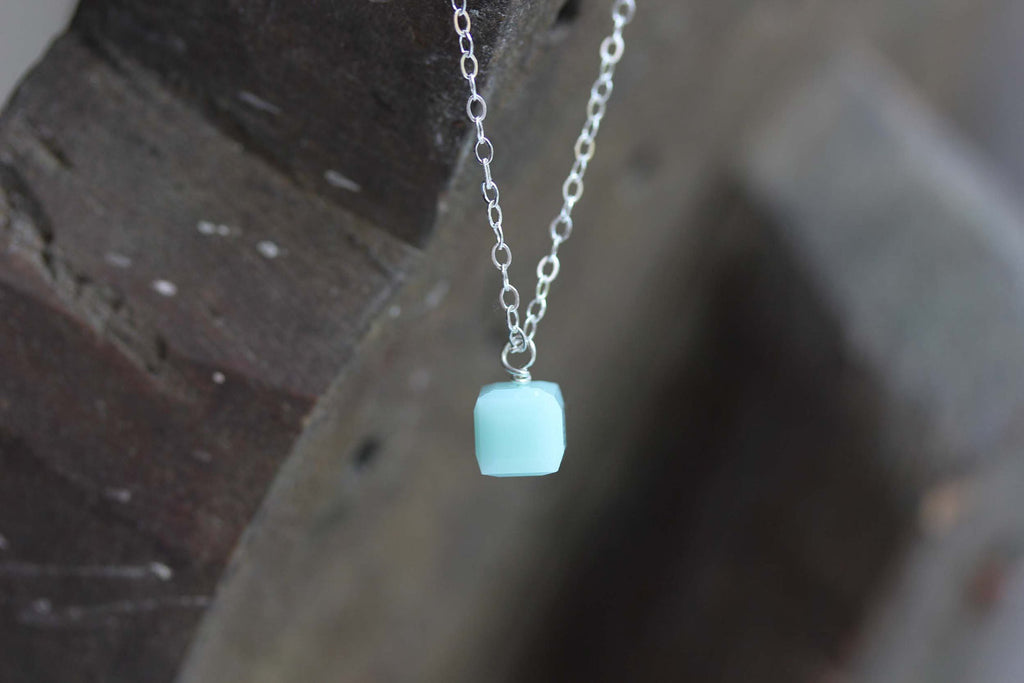 Tiny silver and turquoise cube necklace from Diament Jewelry, a gift shop in Washington, DC.