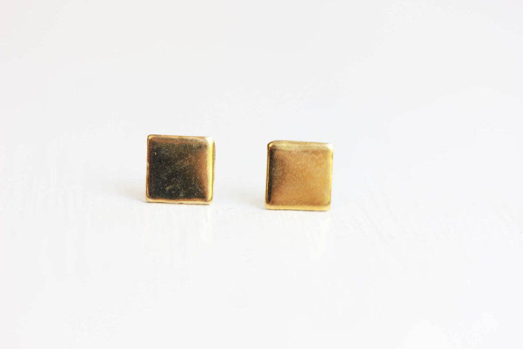 Gold square studs from Diament Jewelry, a gift shop in Washington, DC.