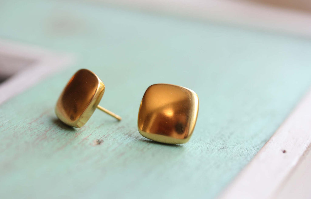 Square gold puffy studs from Diament Jewelry, a gift shop in Washington, DC.
