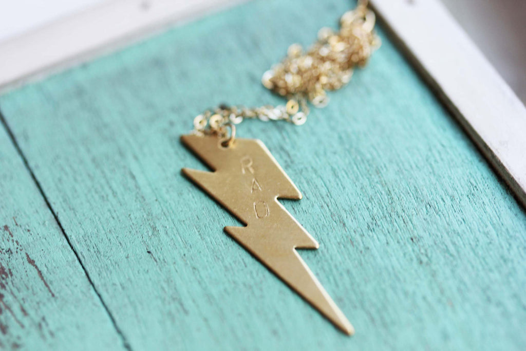 Rad gold lightning bolt necklace from Diament Jewelry, a gift shop in Washington, DC.