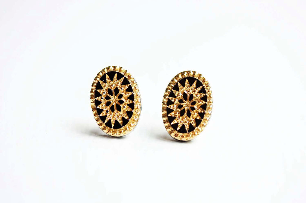 Black and gold starburst studs from Diament Jewelry, a gift shop in Washington, DC.