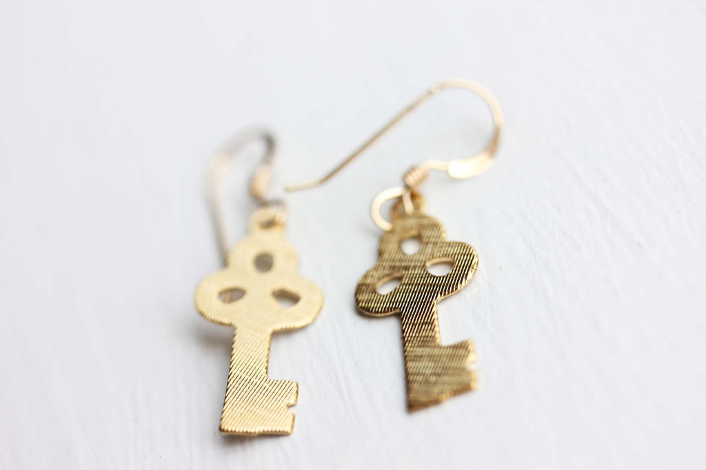 Tiny gold key earrings from Diament Jewelry, a gift shop in Washington, DC.