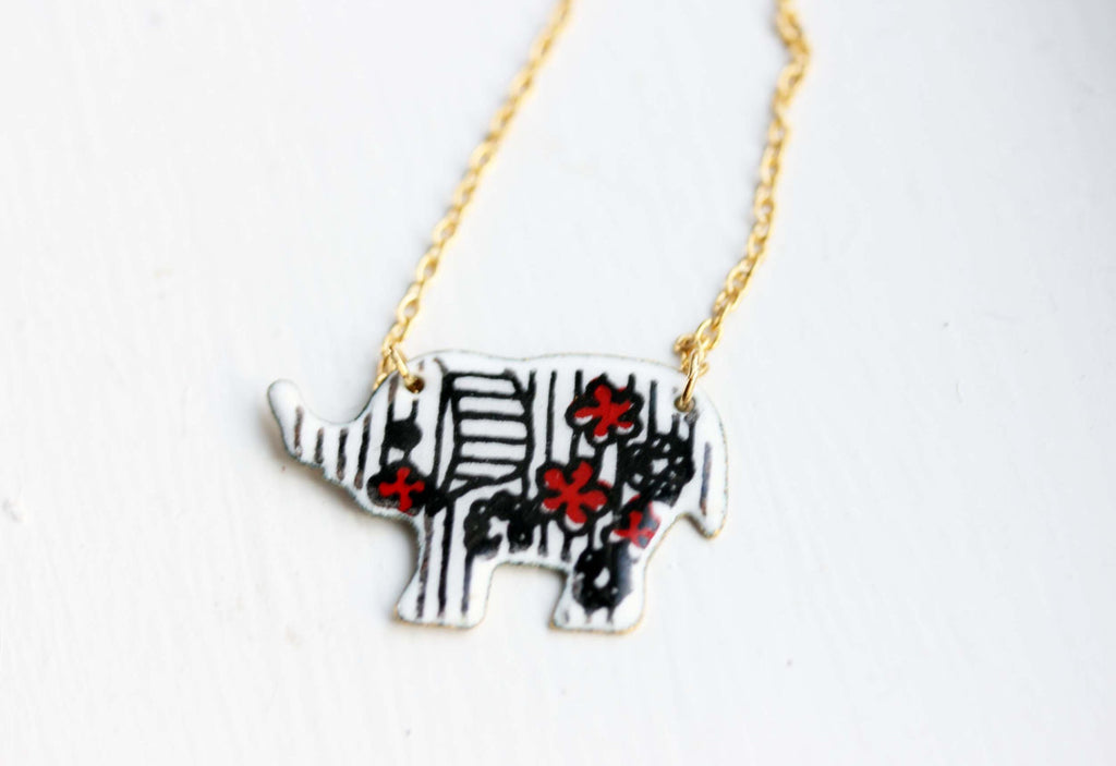 Enamel white elephant gold chain necklace from Diament Jewelry, a gift shop in Washington, DC.