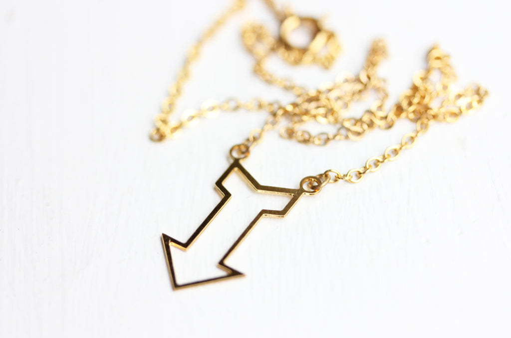 Gold arrow necklace from Diament Jewelry, a gift shop in Washington, DC.
