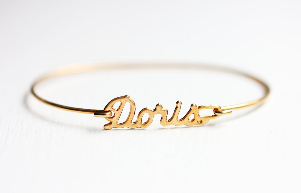 Vintage Doris gold name bracelet from Diament Jewelry, a gift shop in Washington, DC.
