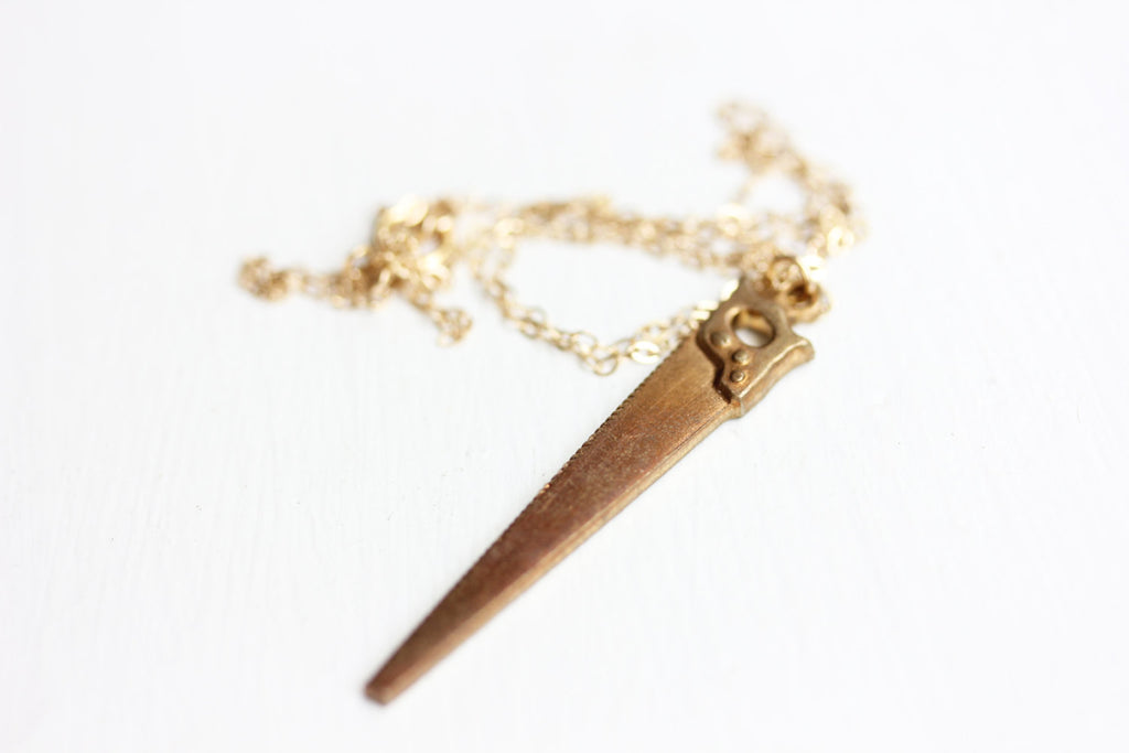 Gold saw necklace from Diament Jewelry, a gift shop in Washington, DC.