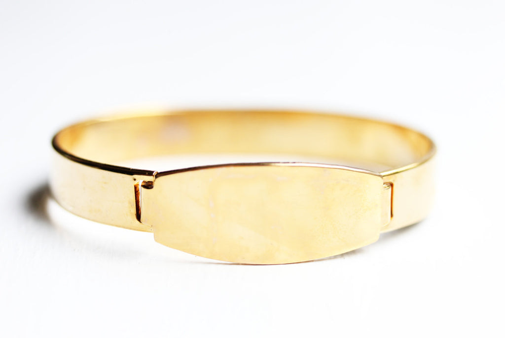 Gold oval bar cuff bracelet from Diament Jewelry, a gift shop in Washington, DC.
