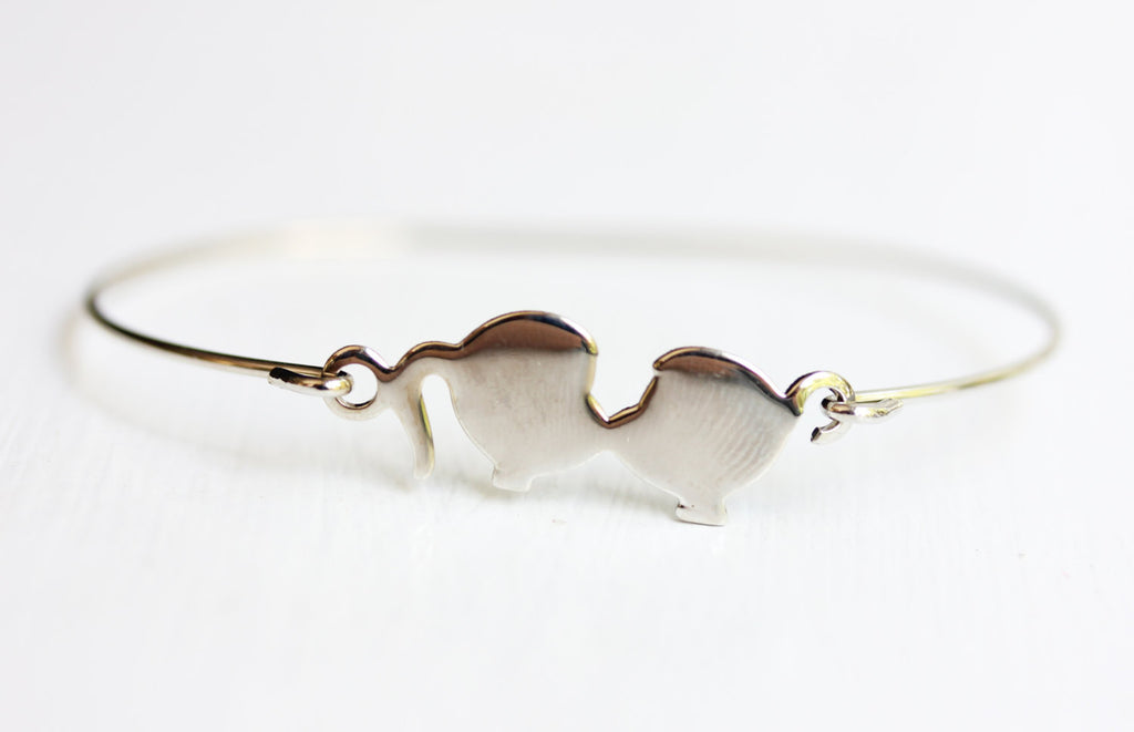 Silver kissy hook bracelet from Diament Jewelry, a gift shop in Washington, DC.