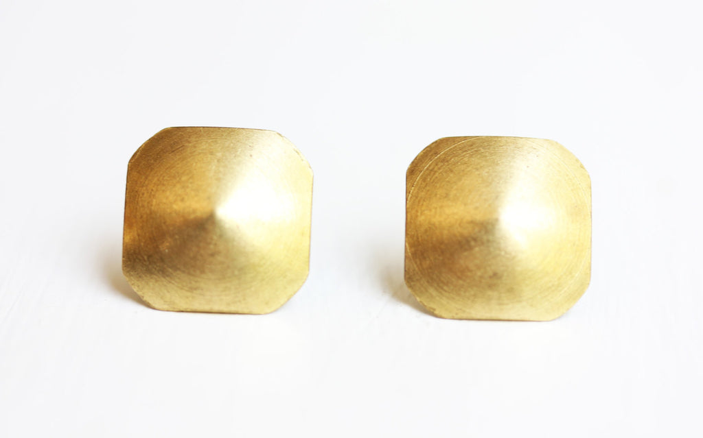 Brass dome square studs from Diament Jewelry, a gift shop in Washington, DC.