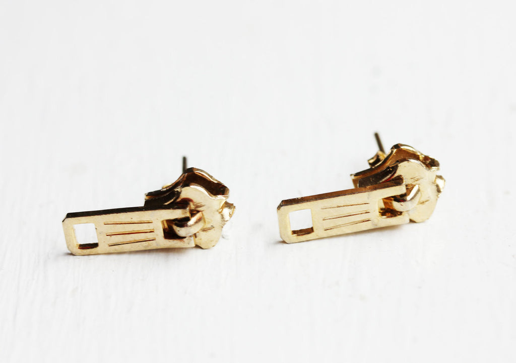 Gold zipper earrings from Diament Jewelry, a gift shop in Washington, DC.