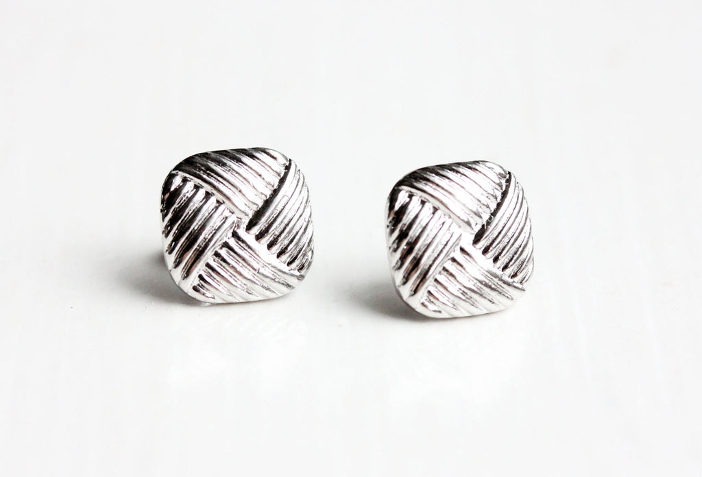 Silver criss cross square studs from Diament Jewelry, a gift shop in Washington, DC.