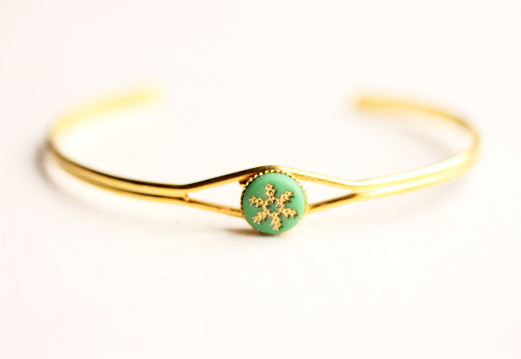 Green starburst gold cuff bracelet from Diament Jewelry, a gift shop in Washington, DC.